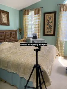 A camera is taking a picture of the bedroom.