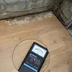 A cell phone sitting on top of a wooden floor.