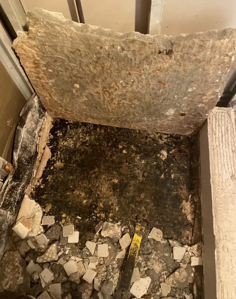 A rotten floor in the corner of a room.