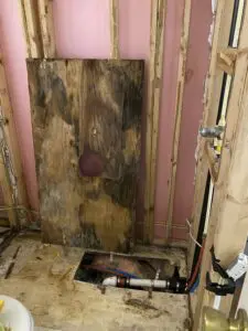 A bathroom with wood walls and floor in it