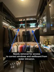 A closet with many clothes hanging on it.