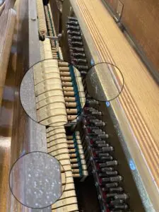 A piano with many bottles of wine on it
